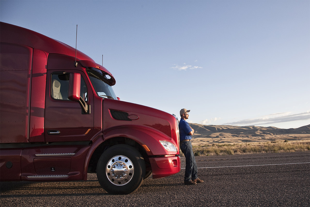 Man leaning on red truck