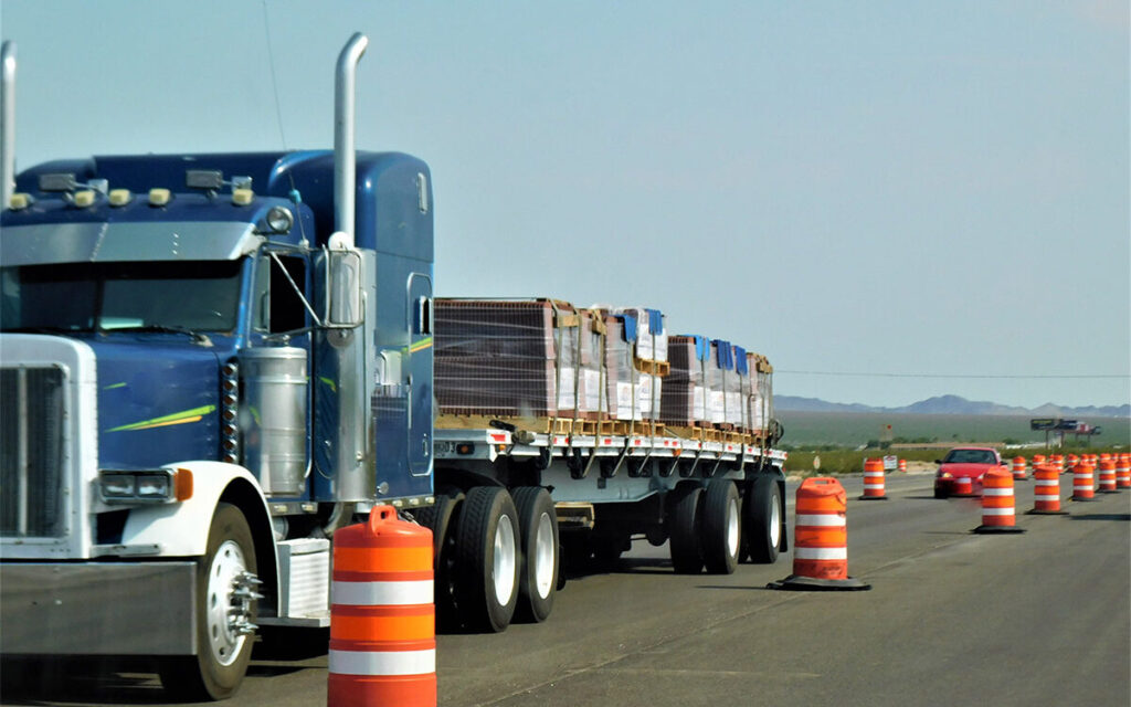 truck surrounded by orange traffic cones with load