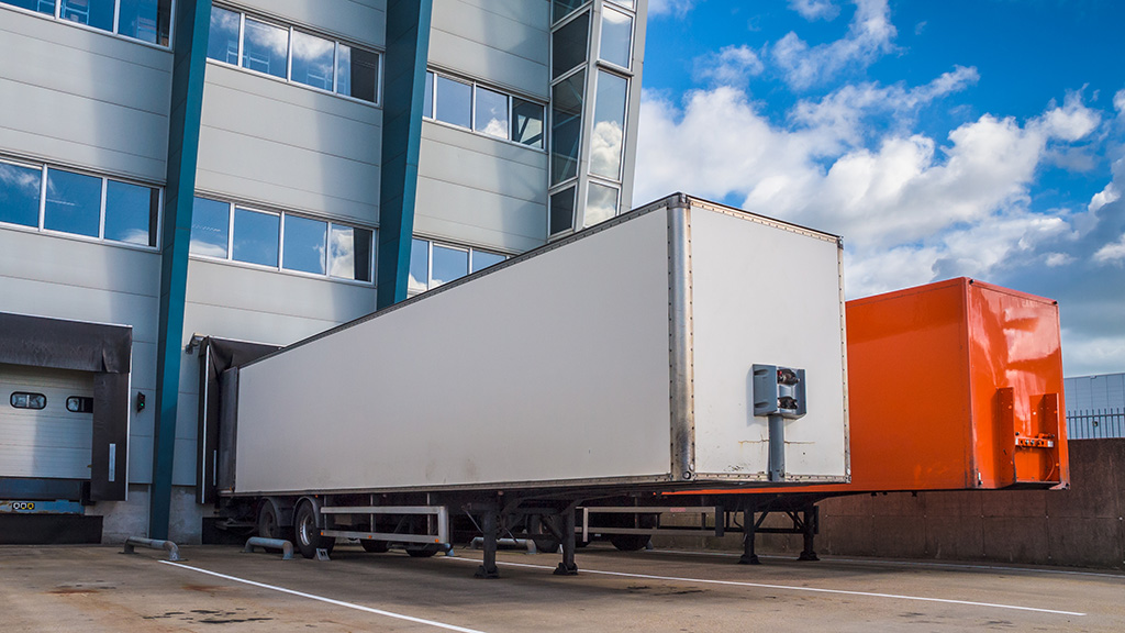 Two truck trailers loading at logistic warehouse distribution centre