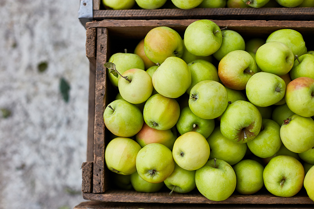 Fresh green apples on wooden boxes, harvest, space for your text, local market or supermarket, Ukraine apples.