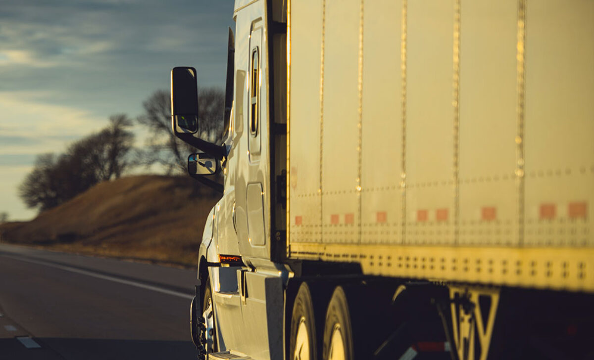 Modern Semi Truck on an American Interstate Highway. Ground Transportation Industry Theme.