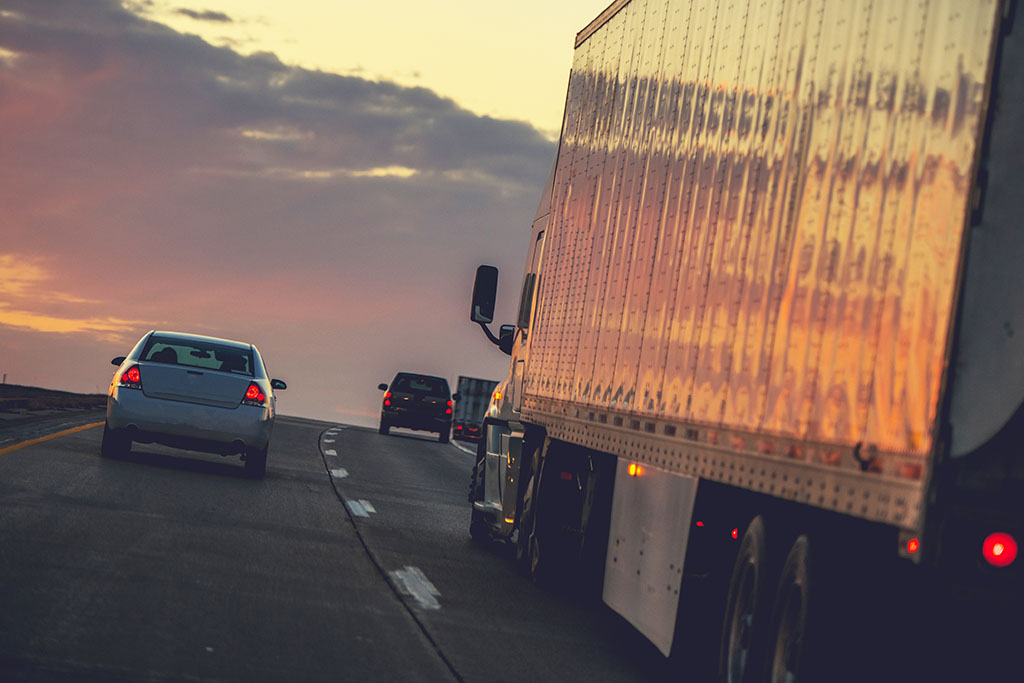 Truck Delivery on the Way. Semi Truck on a Highway. cross docking